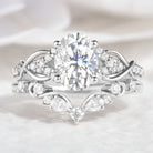 Oval moissanite engagement ring and curved band set, nature-inspired design