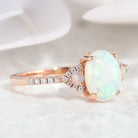 Rose gold opal engagement ring with oval cut opal gemstone