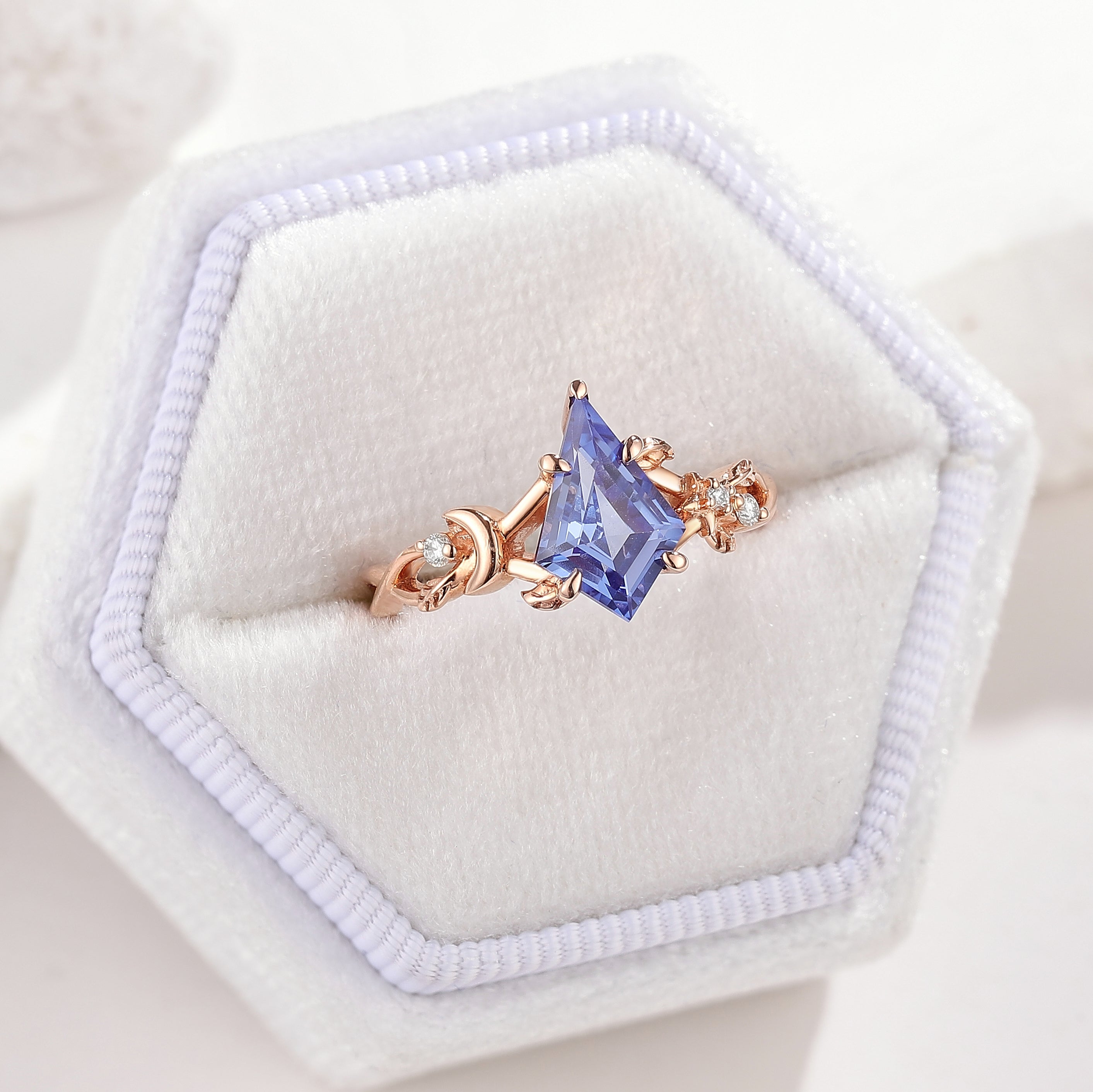 Rose gold kite cut lab sapphire engagement ring with celestial leaf design