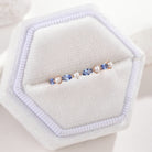 Marquise sapphire and pearl wedding band in a white jewelry box