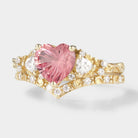 Heart-cut Padparadscha ring set with moissanite accents and gold band