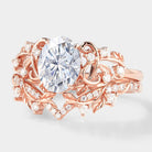 Rose gold leaf engagement ring set with oval moissanite and side stones