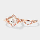 Rose gold leaf-inspired pear moissanite engagement ring set, close-up