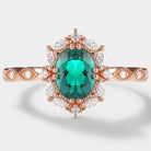 Rose gold emerald and moissanite engagement ring, oval cut