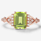 Emerald cut peridot engagement ring in rose gold, featuring moissanite accents and a unique vintage design.