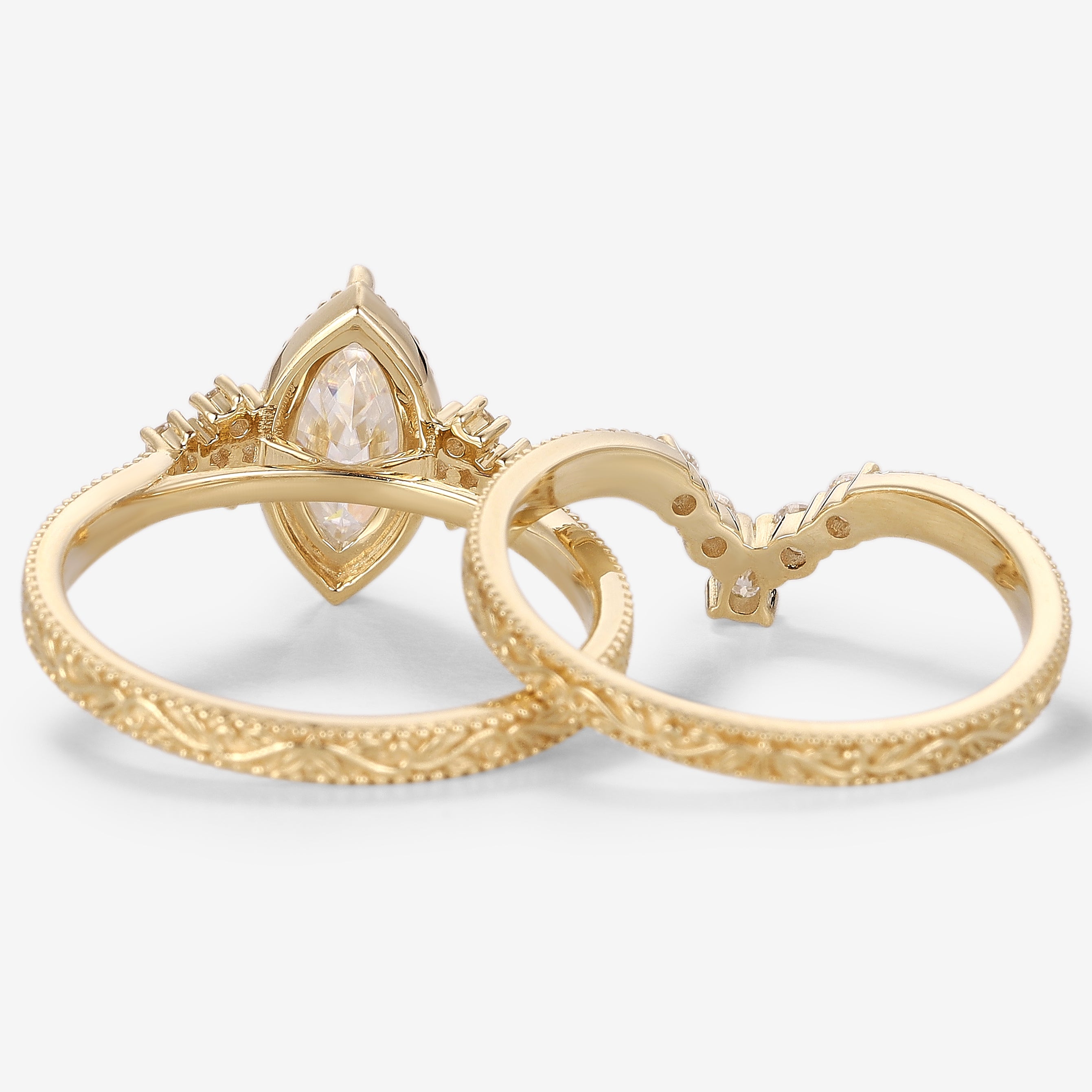 Vintage moissanite engagement ring set in yellow gold, marquise cut center stone with a matching wedding band. Bridal set.