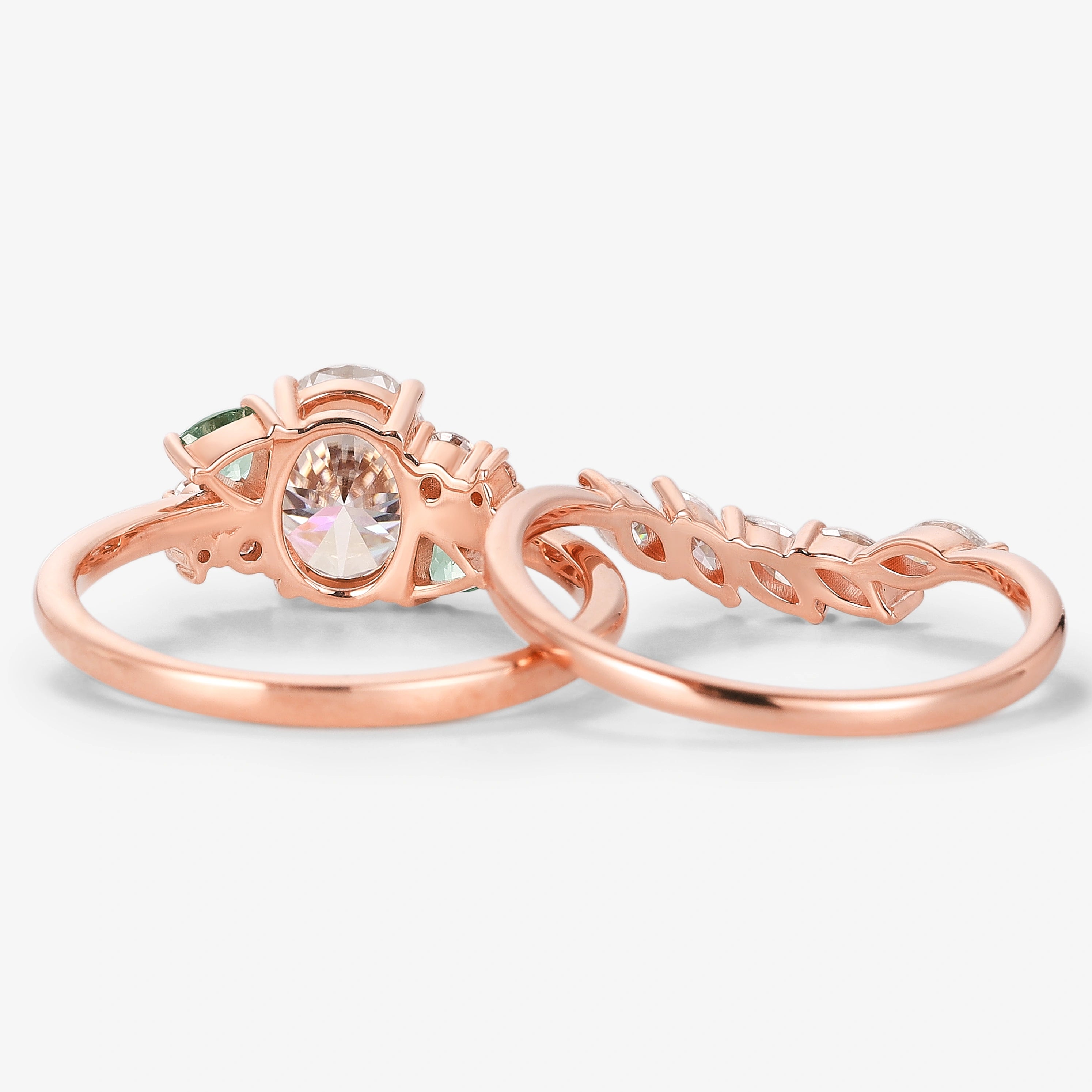 Rose gold oval moissanite bridal set with triangle spinel cluster, vintage style engagement ring and wedding band.
