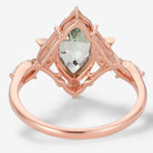 Rose gold marquise green sapphire engagement ring with moon and moissanite accents, vintage design.