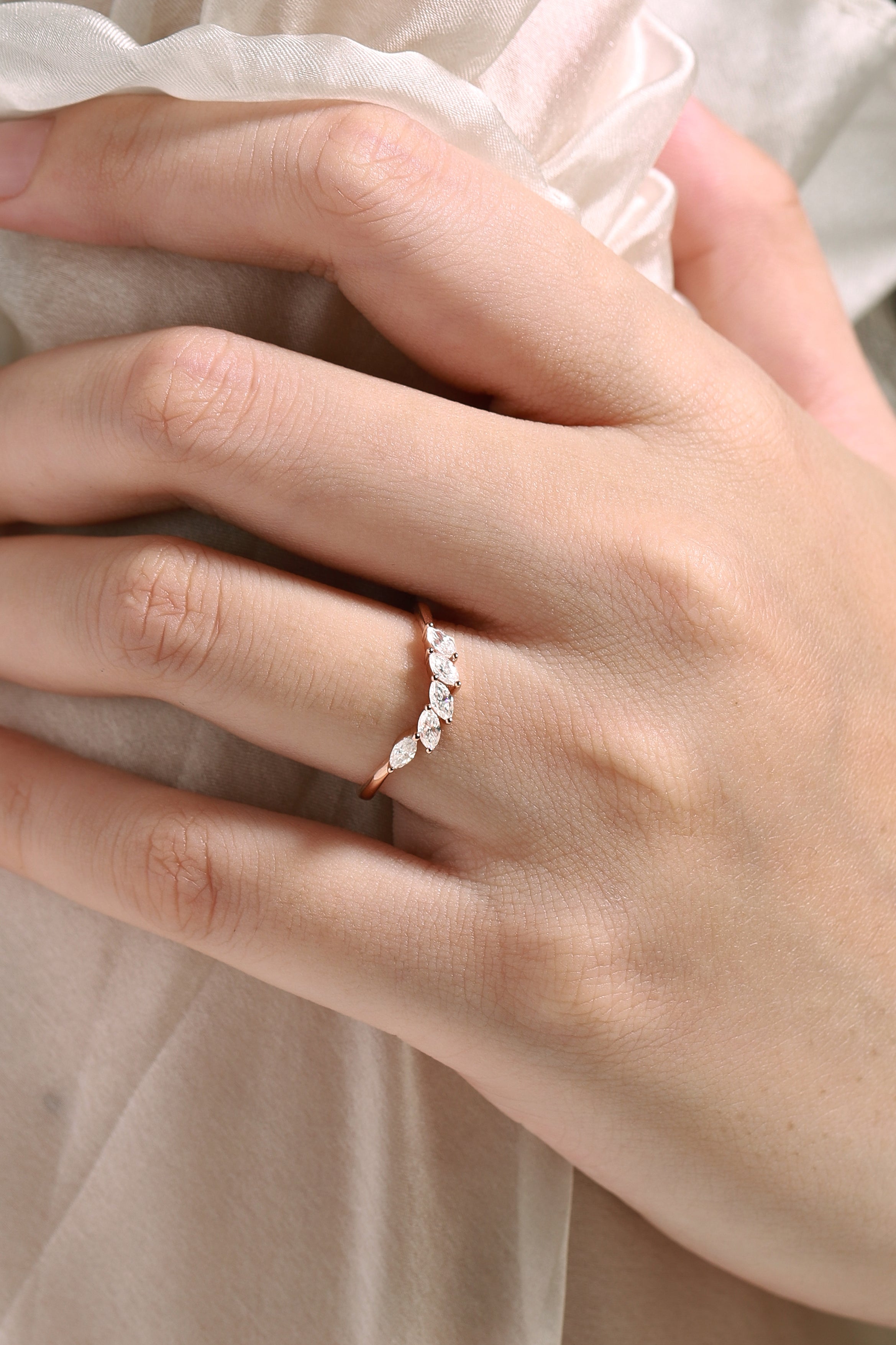 Rose gold wedding band with marquise moissanite stones, perfect for engagement. Shop wedding rings.