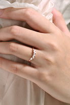 Rose gold wedding band with marquise moissanite stones, perfect for engagement. Shop wedding rings.