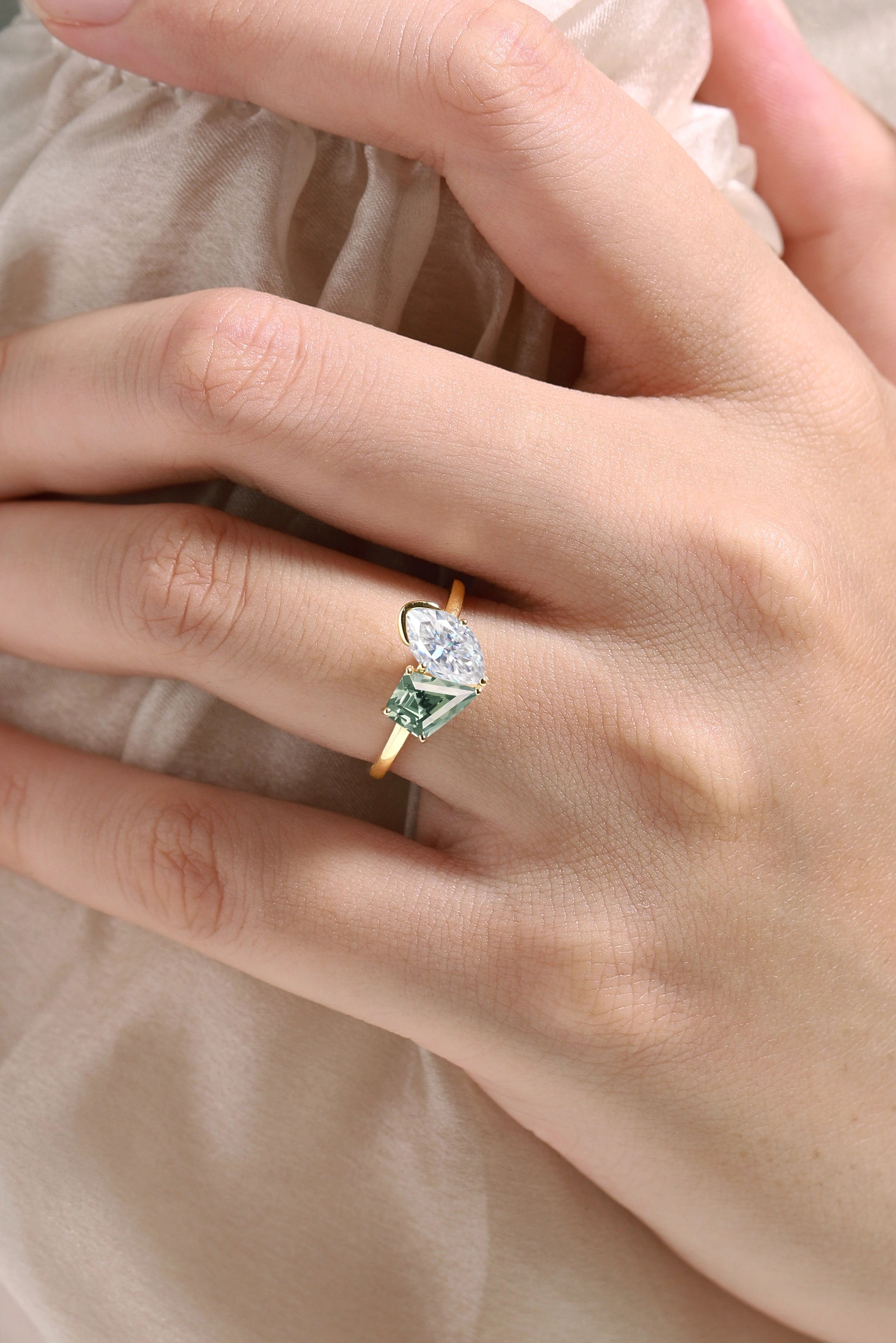 Engagement ring with marquise moissanite and kite-cut green sapphire in yellow gold, Lahela Jewelry.