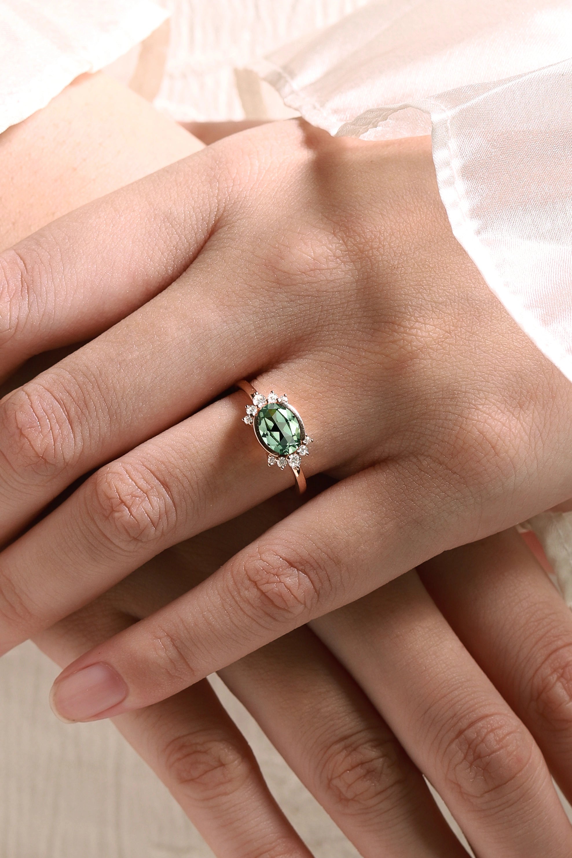 Rose gold engagement ring with oval green sapphire and moissanite accents. Wedding ring.