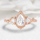 Nature-Inspired Pear Cut Moissanite Bezel Engagement Ring with Trillion Accent Stones - Emily
