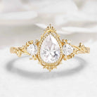 Nature-Inspired Pear Cut Moissanite Bezel Engagement Ring with Trillion Accent Stones - Emily