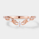 Vintage-inspired moissanite chevron wedding band in rose gold, perfect bridal set.