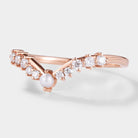 Rose gold curved wedding band with moissanite and pearl accents, bridal ring set