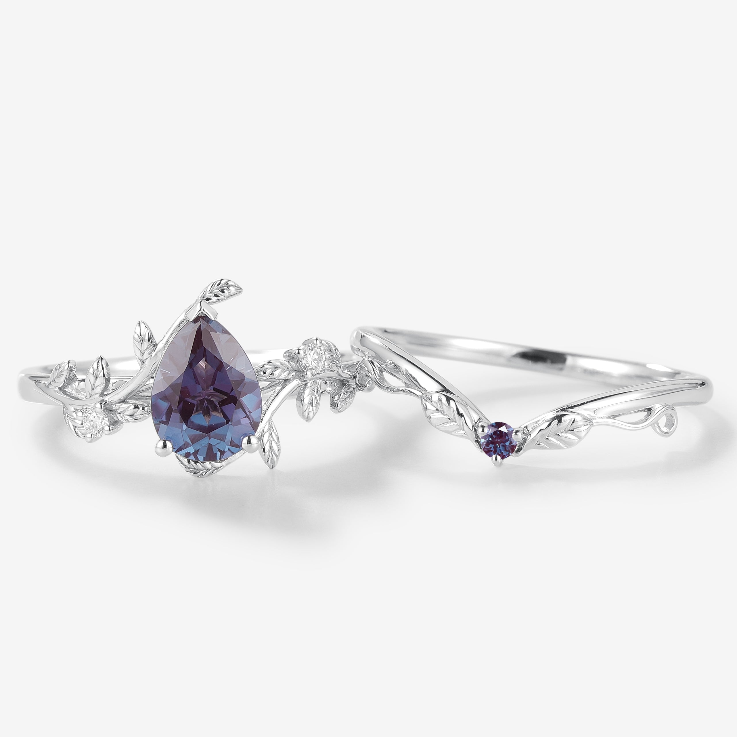 Pear cut alexandrite engagement ring set with leaf design, vintage style. Includes bridal ring and wedding band.