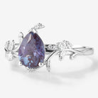 Pear-cut Alexandrite leaf engagement ring in white gold with moissanite accents. Vintage style.
