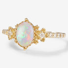 Floralis oval cut opal engagement ring with floral design, moissanite accents and gold band