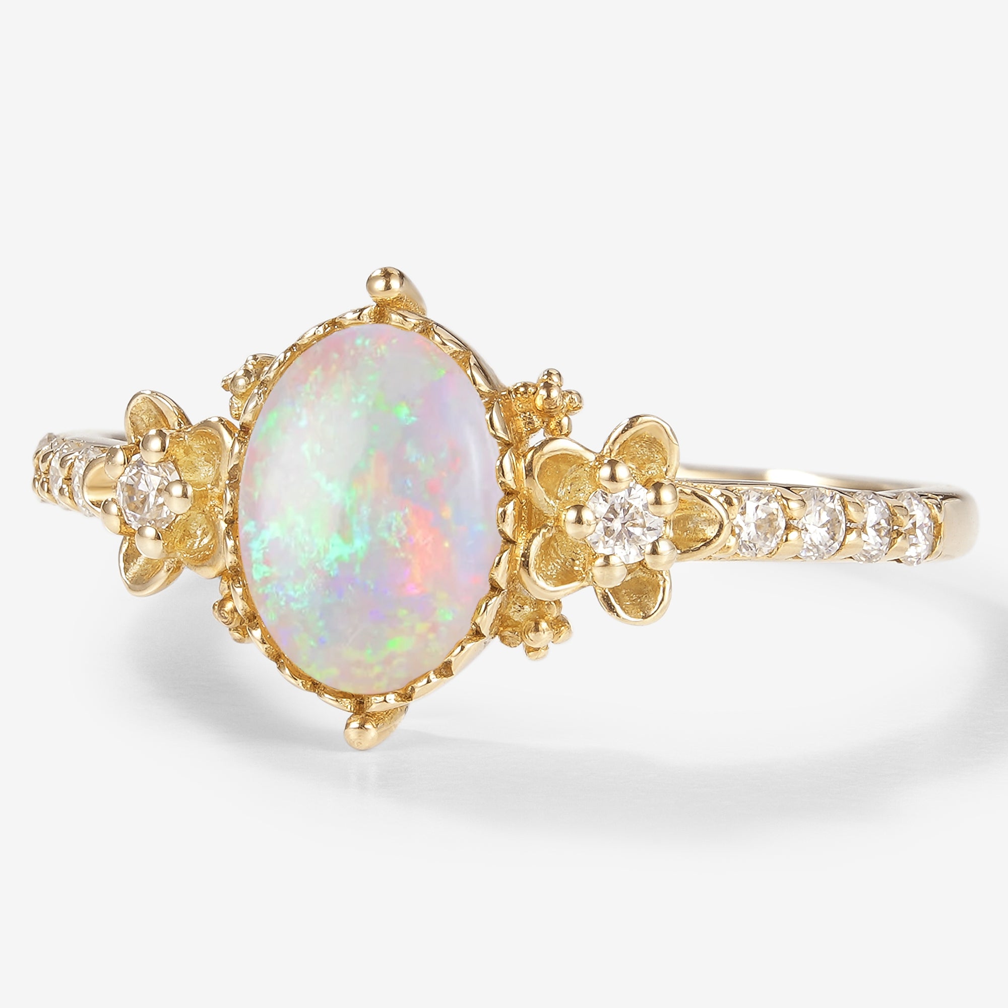 Floralis oval cut opal engagement ring with floral design, moissanite accents and gold band