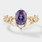 Oval cut alexandrite engagement ring with moissanite accents and a floral design in yellow gold. Bridal ring set.