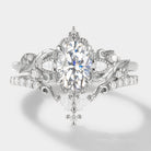 Elongated oval cut moissanite ring set in white gold. Leaf design engagement ring & wedding band. Bridal ring set.