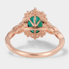 Vintage rose gold lab grown emerald engagement ring, oval cut with intricate filigree detailing