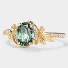 Oval lab grown green sapphire engagement ring with leaf and moissanite accents in gold, vintage style, bridal set