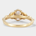 Rear view of gold oval moissanite engagement ring with leaf design, Leafora ring, showcasing band and gemstone details.