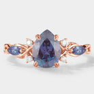 Classic pear cut alexandrite engagement ring with rose gold band and moissanite accents. Vintage design.