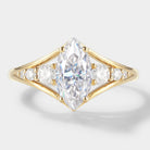 Marquise cut moissanite engagement ring in 14k gold. Featuring a stunning center stone and accent stones, a timeless beauty.