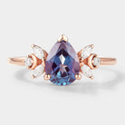 Pear cut alexandrite engagement ring with moissanite cluster, rose gold band, bridal set