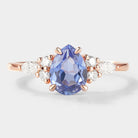 Pear cut cornflower sapphire engagement ring with moissanite accents, rose gold band, bridal set rings