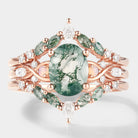 Rose gold moss agate engagement ring with enhancer double wedding band. Featuring moss agate, opal, moissanite, and diamonds.