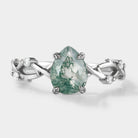 Pear cut moss agate engagement ring with leaf and vine design